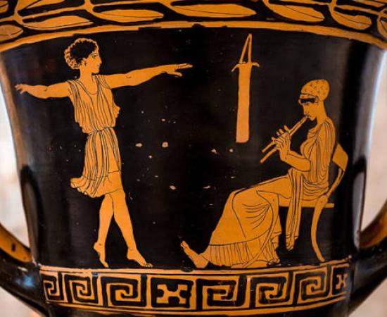A dancing girl and woman (music teacher) seated on chair playing auloi on red and black ceramic.