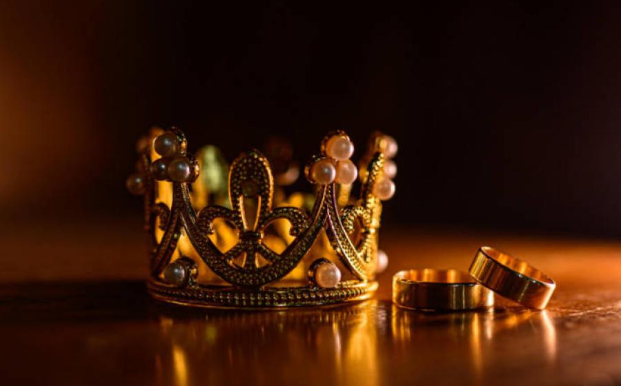 A bejewelled crown and rings, representative of gemstones showing power.
