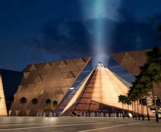 Exterior view of the Grand Egyptian Museum at night.