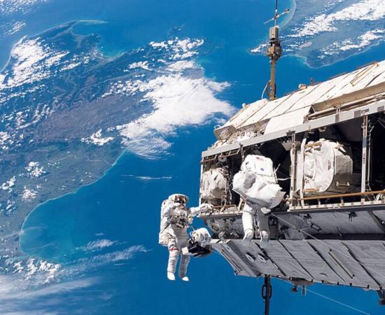 View from the International Space Station, looking down at a blue and fertile Earth where life has blossomed.