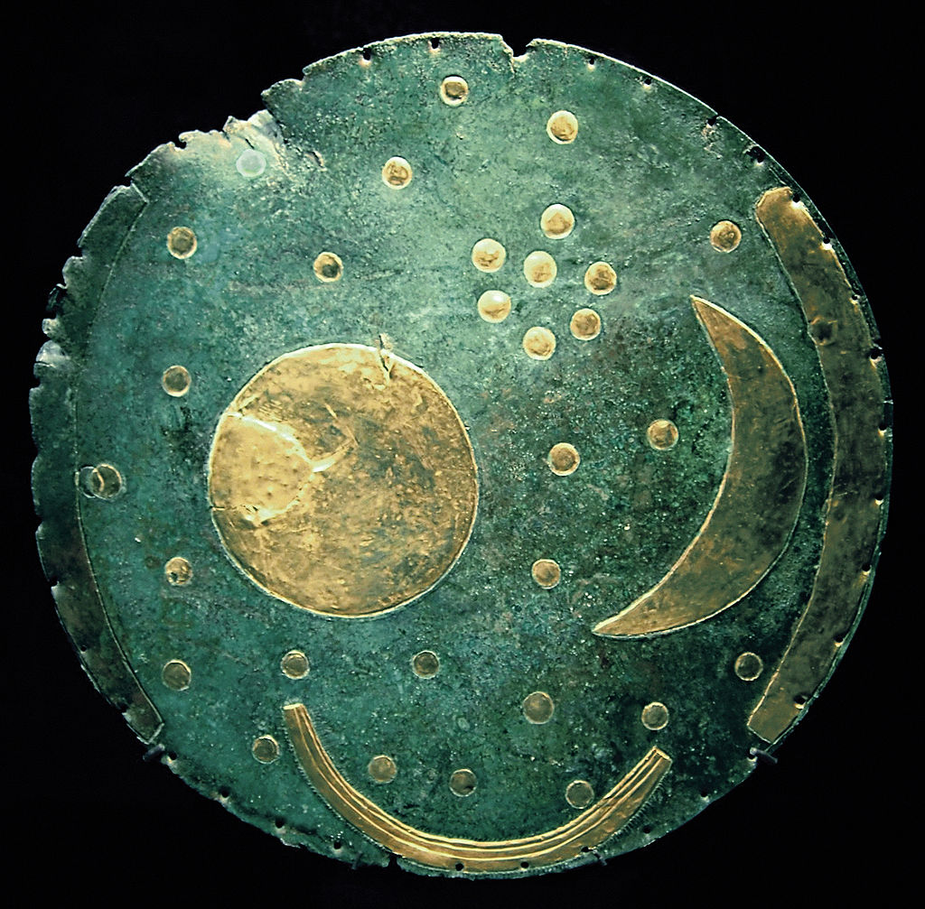 The Nebra sky disk is a bronze disk of around 30 cm diameter and a weight of 2.2 kg, with a blue-green patina and inlaid with gold symbols. (Source: Wikipedia)