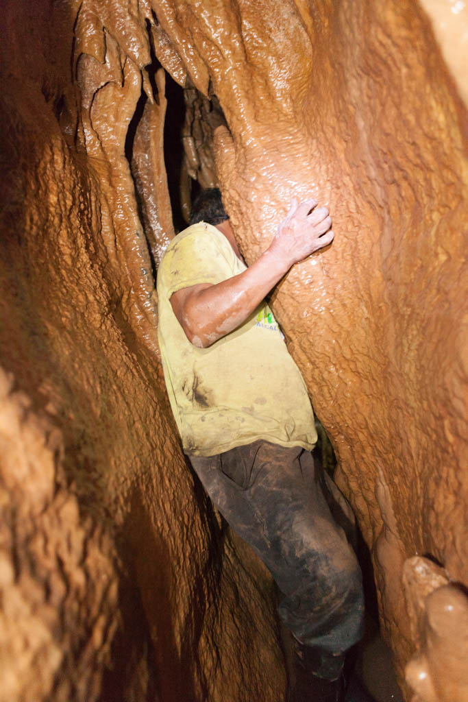 Squizing through small tunnel - Tayos Caves