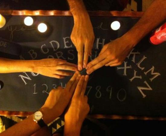 People using a Ouija board